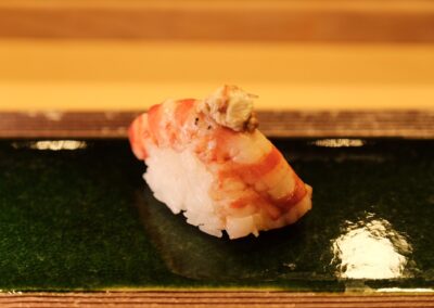 Fresh kuruma ebi nigiri topped with a rich shrimp miso, served at Sushi Shutatsu in Ogikubo.