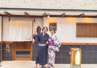 Guests in yukata standing in front of Sushi Shutatsu in Ogikubo, Tokyo.